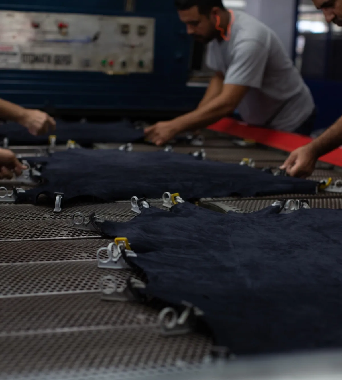 Technicians preparing denim panels on the production line